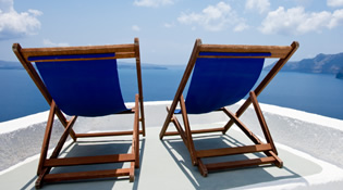 Blue wooden deckchairs overlooking the sea